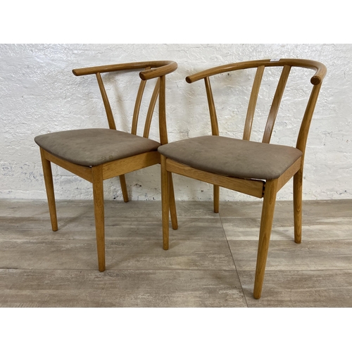 23 - A pair of Artenara wishbone style oak bentwood and fabric upholstered dining chairs