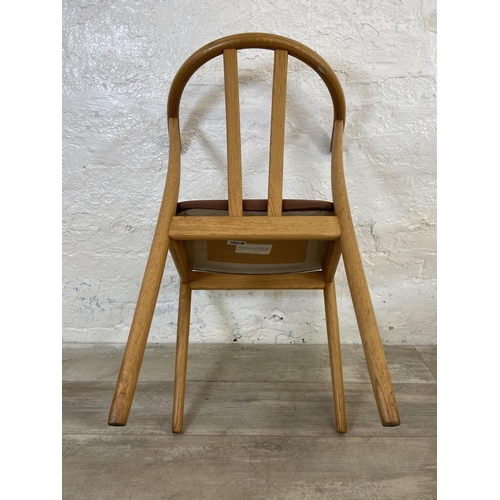 23 - A pair of Artenara wishbone style oak bentwood and fabric upholstered dining chairs