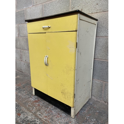 31 - Seven mid 20th century items, one yellow painted kitchen cabinet, two electric irons, one beech fold... 