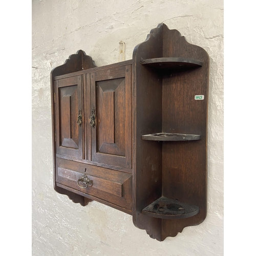 32 - An Arts & Crafts oak wall hanging two door smoker's cabinet - approx. 70cm high x 68cm wide