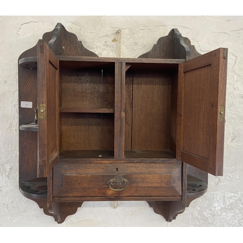 32 - An Arts & Crafts oak wall hanging two door smoker's cabinet - approx. 70cm high x 68cm wide