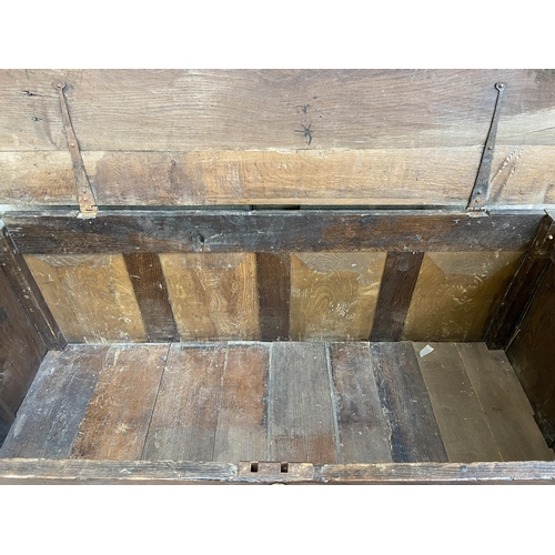 35 - A Georgian oak four panel mule chest - approx. 100cm high x 152cm wide x 67cm deep