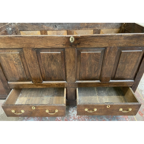 35 - A Georgian oak four panel mule chest - approx. 100cm high x 152cm wide x 67cm deep