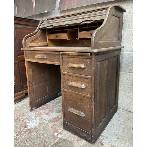 36 - An early 20th century Angus of London oak roll top desk - approx. 113cm high x 90cm wide x 65cm deep