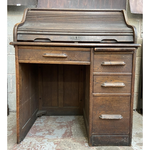 36 - An early 20th century Angus of London oak roll top desk - approx. 113cm high x 90cm wide x 65cm deep