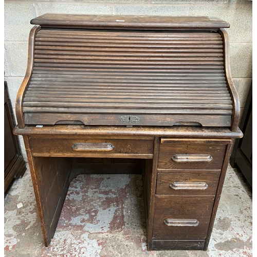 36 - An early 20th century Angus of London oak roll top desk - approx. 113cm high x 90cm wide x 65cm deep