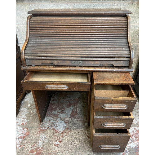 36 - An early 20th century Angus of London oak roll top desk - approx. 113cm high x 90cm wide x 65cm deep