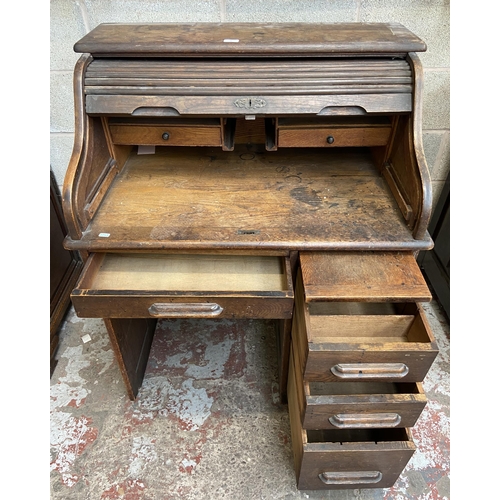 36 - An early 20th century Angus of London oak roll top desk - approx. 113cm high x 90cm wide x 65cm deep