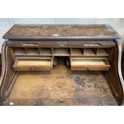 36 - An early 20th century Angus of London oak roll top desk - approx. 113cm high x 90cm wide x 65cm deep