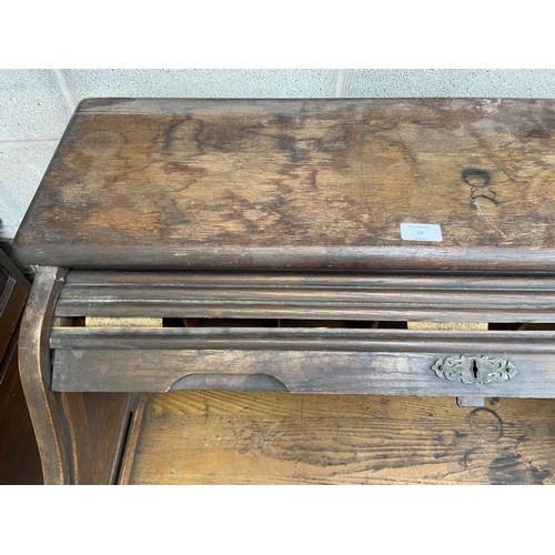 36 - An early 20th century Angus of London oak roll top desk - approx. 113cm high x 90cm wide x 65cm deep