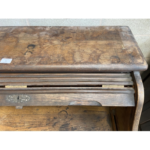 36 - An early 20th century Angus of London oak roll top desk - approx. 113cm high x 90cm wide x 65cm deep