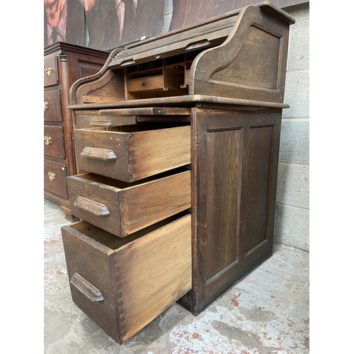 36 - An early 20th century Angus of London oak roll top desk - approx. 113cm high x 90cm wide x 65cm deep