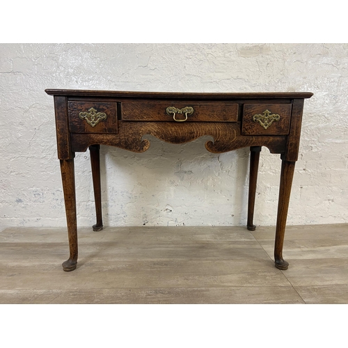 39B - A Georgian oak three drawer lowboy/side table on cabriole supports - approx. 72cm high x 97cm wide x... 