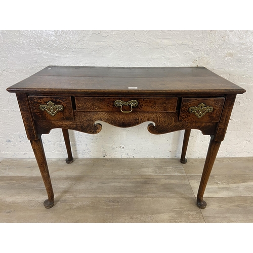 39B - A Georgian oak three drawer lowboy/side table on cabriole supports - approx. 72cm high x 97cm wide x... 