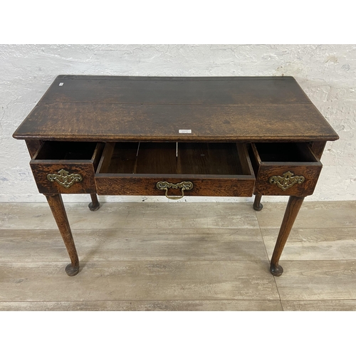 39B - A Georgian oak three drawer lowboy/side table on cabriole supports - approx. 72cm high x 97cm wide x... 