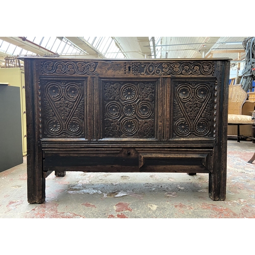 39C - A 18th century carved oak mule chest - approx. 85cm high x 120cm wide x 52cm deep