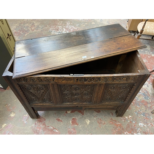 39C - A 18th century carved oak mule chest - approx. 85cm high x 120cm wide x 52cm deep