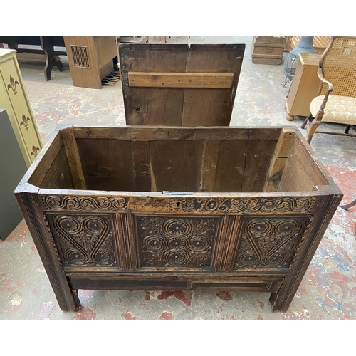 39C - A 18th century carved oak mule chest - approx. 85cm high x 120cm wide x 52cm deep