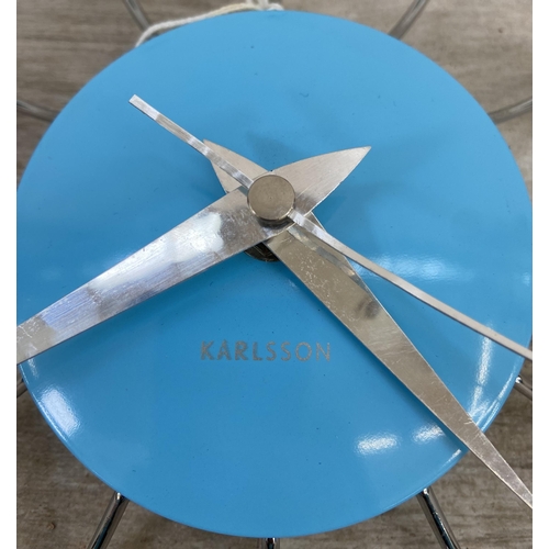 41 - A mid 20th century style Karlsson blue plastic and chrome plated steel wall clock - approx. 28cm dia... 