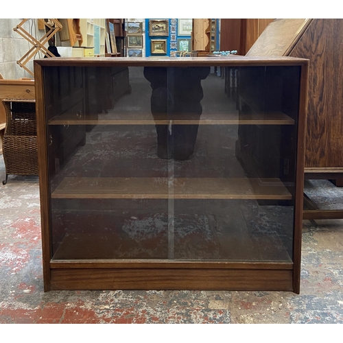 42C - A mid 20th century Herbert E. Gibbs teak bookcase with two glass sliding doors - approx. 83cm high x... 