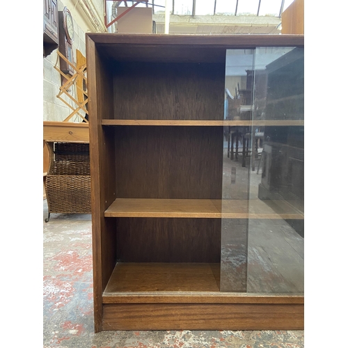 42C - A mid 20th century Herbert E. Gibbs teak bookcase with two glass sliding doors - approx. 83cm high x... 