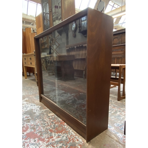 42C - A mid 20th century Herbert E. Gibbs teak bookcase with two glass sliding doors - approx. 83cm high x... 