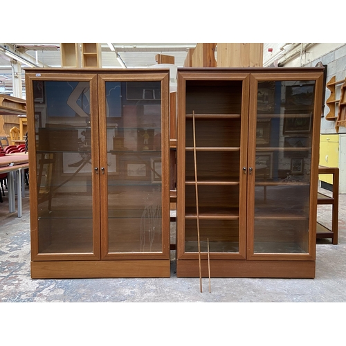 48 - Two mid 20th century teak display cabinets - approx. 124cm high x 82cm wide x 30cm deep