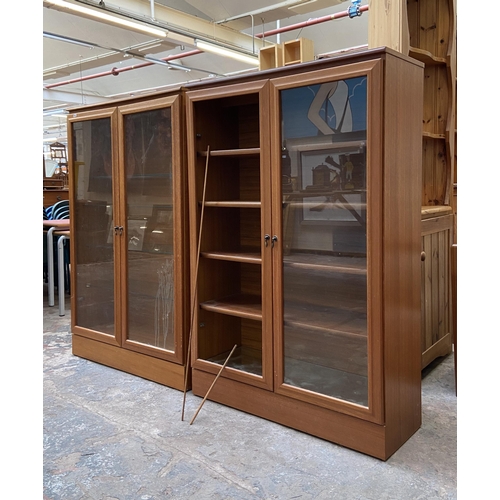 48 - Two mid 20th century teak display cabinets - approx. 124cm high x 82cm wide x 30cm deep