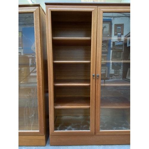 48 - Two mid 20th century teak display cabinets - approx. 124cm high x 82cm wide x 30cm deep