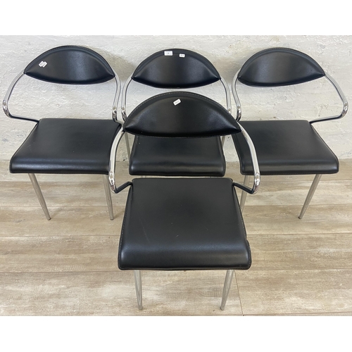 63 - Four chrome plated and black vinyl dining chairs