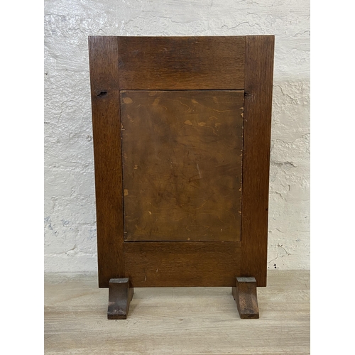 63A - An early 20th century carved oak and marquetry inlaid fire screen - approx. 65cm high x 42cm wide