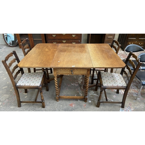 63C - An early 20th century oak drop leaf gate leg dining table on barley twist supports and four 19th cen... 