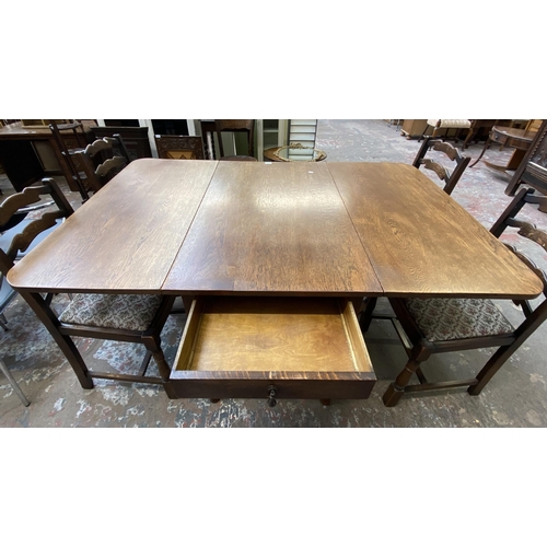 63C - An early 20th century oak drop leaf gate leg dining table on barley twist supports and four 19th cen... 