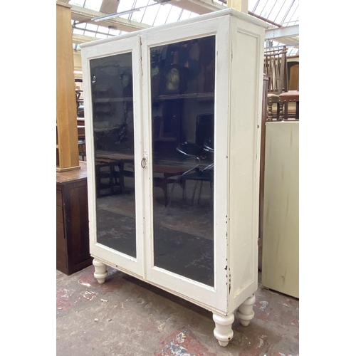 66 - An early 20th century white painted two door glazed bookcase - approx. 140cm high x 95cm wide x 30cm... 