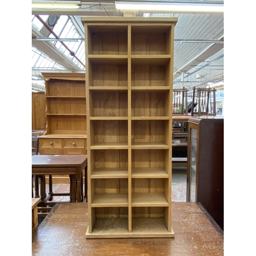 67 - A modern oak CD shelving unit - approx. 113cm high x 47cm wide x 17cm deep