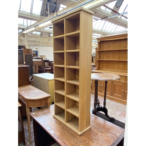 67 - A modern oak CD shelving unit - approx. 113cm high x 47cm wide x 17cm deep