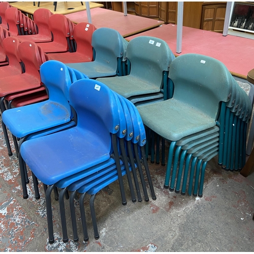 79 - Thirty mid/late 20th century plastic and tubular metal stacking children's school chairs