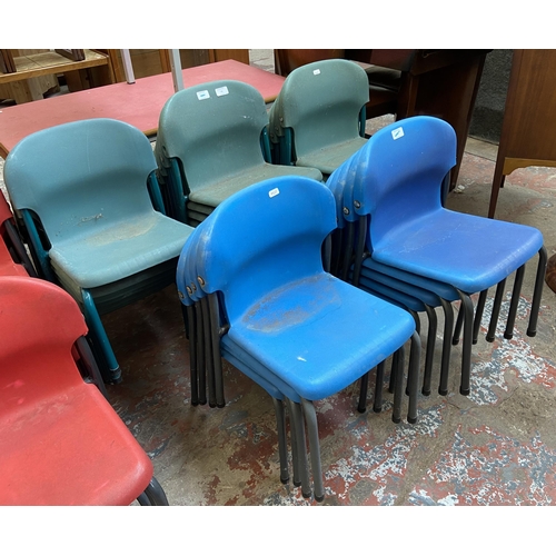 79 - Thirty mid/late 20th century plastic and tubular metal stacking children's school chairs