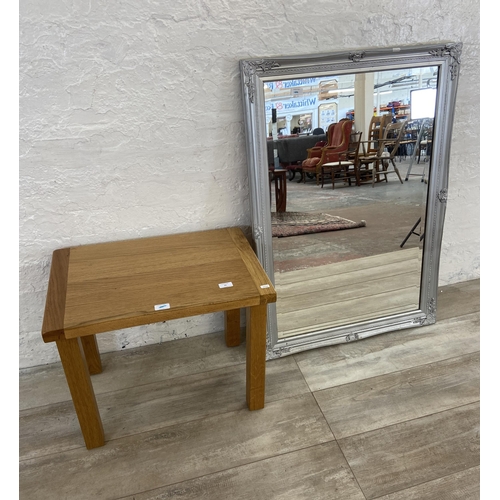 81 - Two items, one modern oak side table and one Dunelm silver painted framed bevelled edge wall mirror ... 