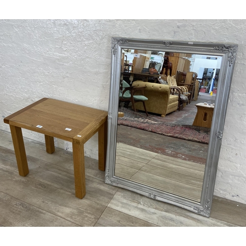 81 - Two items, one modern oak side table and one Dunelm silver painted framed bevelled edge wall mirror ... 