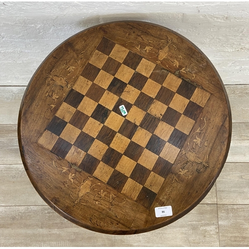 86 - A Victorian inlaid walnut circular tripod pedestal chess table - approx. 66cm high x 53cm diameter