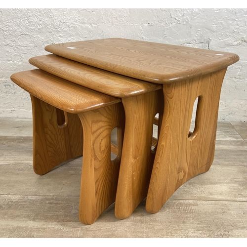 9 - An Ercol Windsor blonde elm nest of tables - approx. 45cm high x 63cm wide x 41cm deep