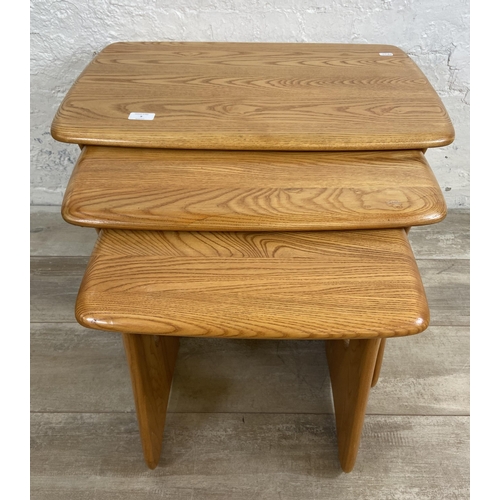 9 - An Ercol Windsor blonde elm nest of tables - approx. 45cm high x 63cm wide x 41cm deep