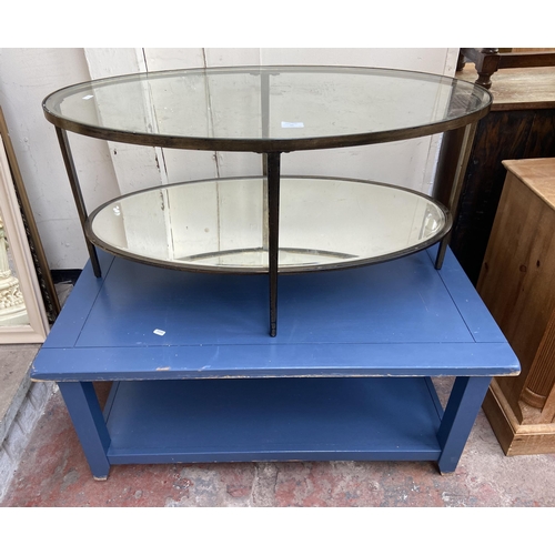 96 - Two modern coffee tables, one gilt metal oval two tier with mirrored glass and one blue painted rect... 