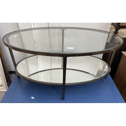 96 - Two modern coffee tables, one gilt metal oval two tier with mirrored glass and one blue painted rect... 