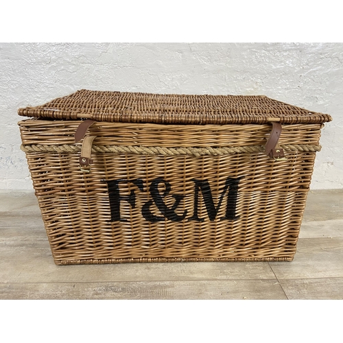 105 - A Fortnum & Mason wicker basket with rope handles - approx. 48cm high x 79cm wide x 51cm deep