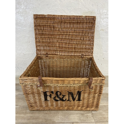 105 - A Fortnum & Mason wicker basket with rope handles - approx. 48cm high x 79cm wide x 51cm deep