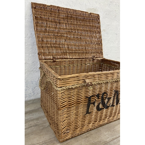 105 - A Fortnum & Mason wicker basket with rope handles - approx. 48cm high x 79cm wide x 51cm deep