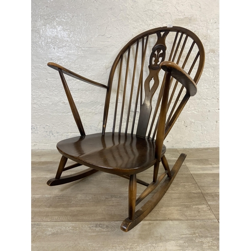 122 - A mid 20th century Ercol Fleur De Lys elm and beech rocking chair