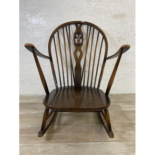 122 - A mid 20th century Ercol Fleur De Lys elm and beech rocking chair